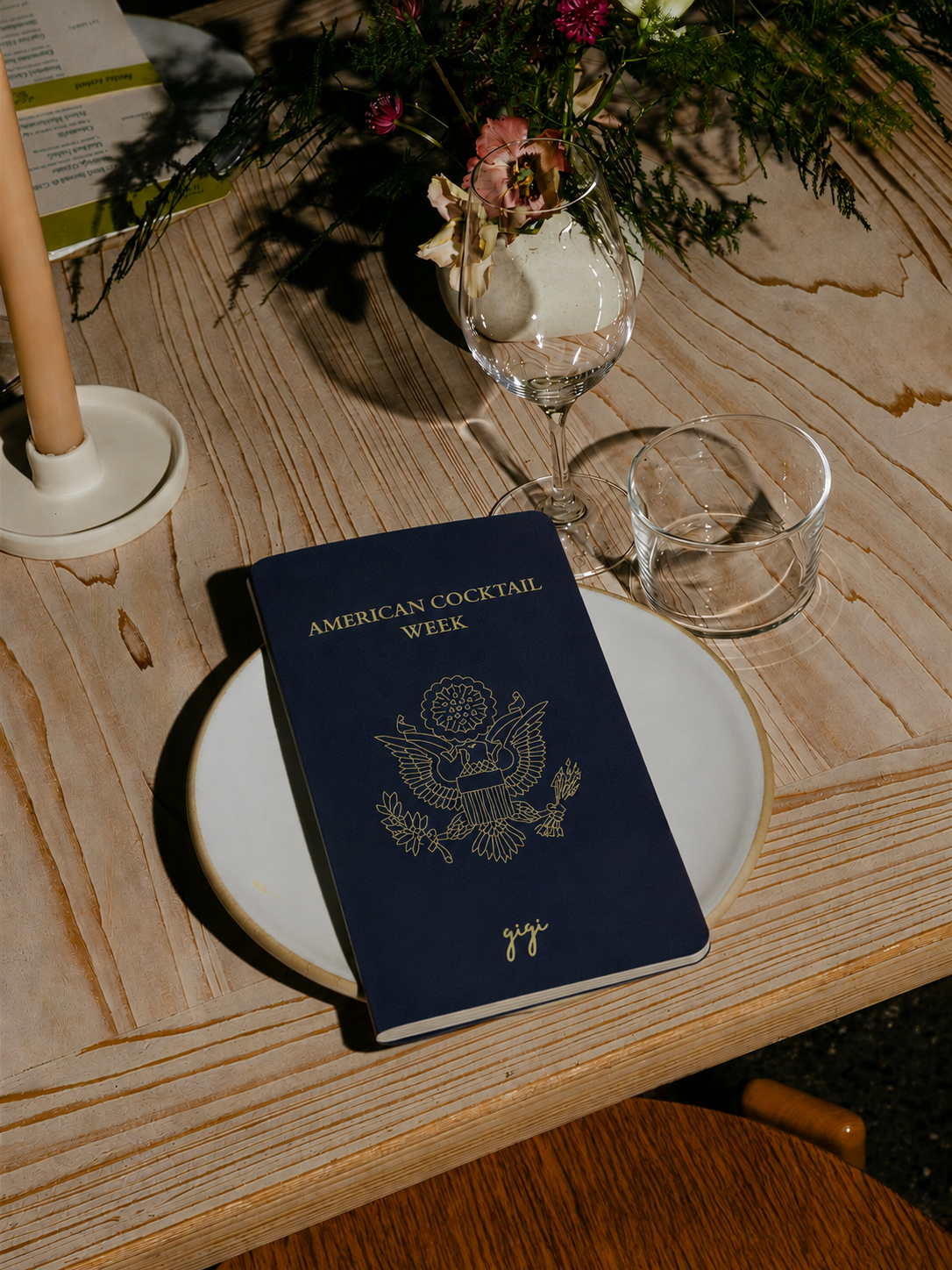 The passport-style menu resting on a plate in evening light