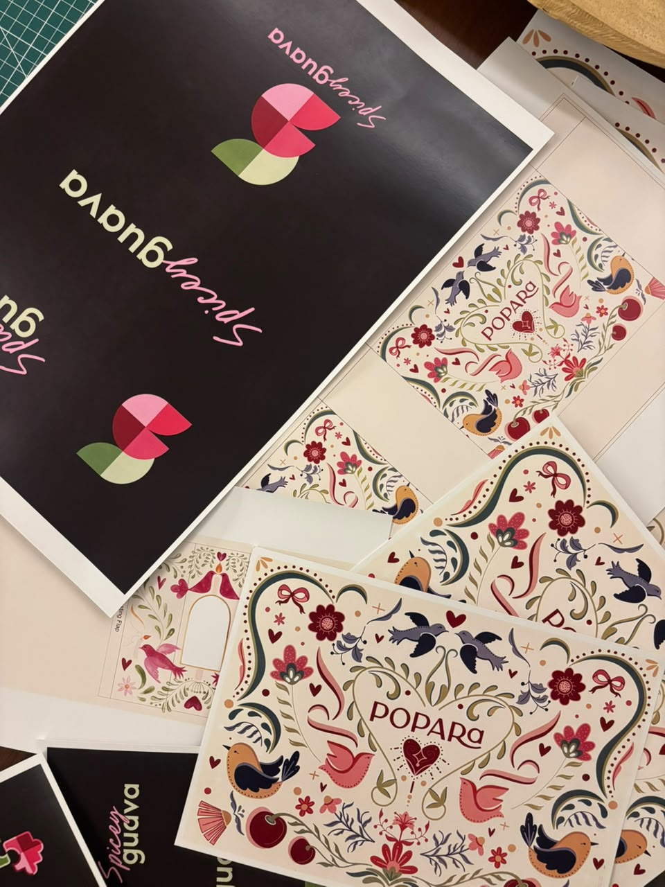 Print proofs of Spicey Guava branding alongside illustrated Popara packaging artwork