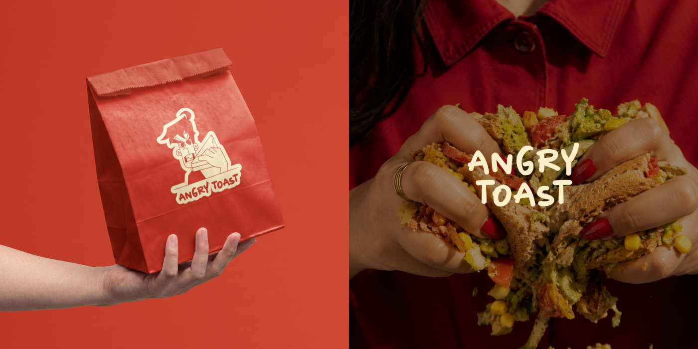 Branded paper bag held in hand and a loaded sandwich held with both hands
