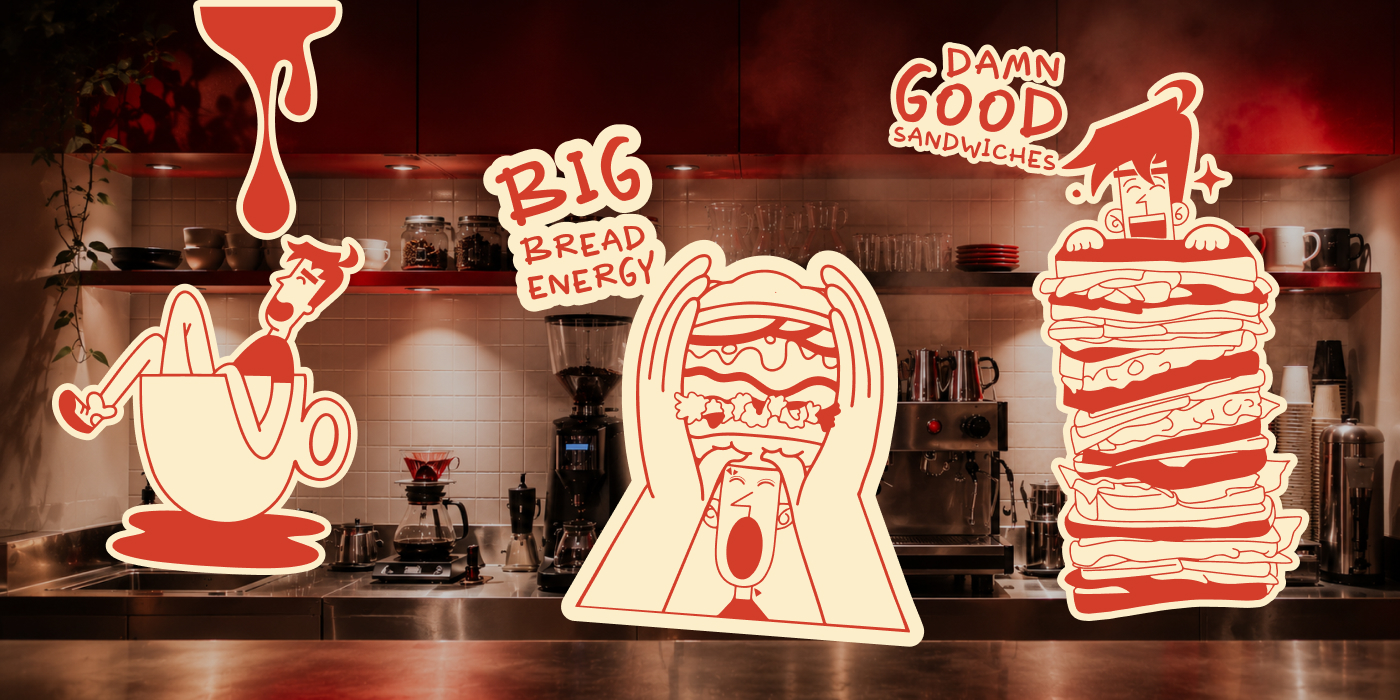 Sticker set including Big Bread Energy and Damn Good Sandwiches applied over a cafe counter